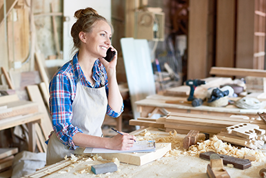 A business owner in a wood workshop.