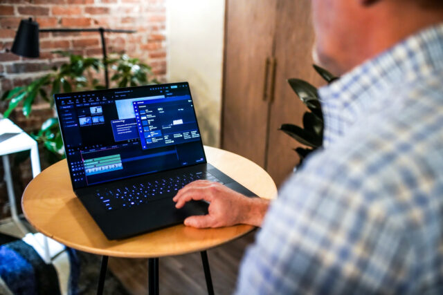 View from over shoulder of male user using Dell XPS laptop 