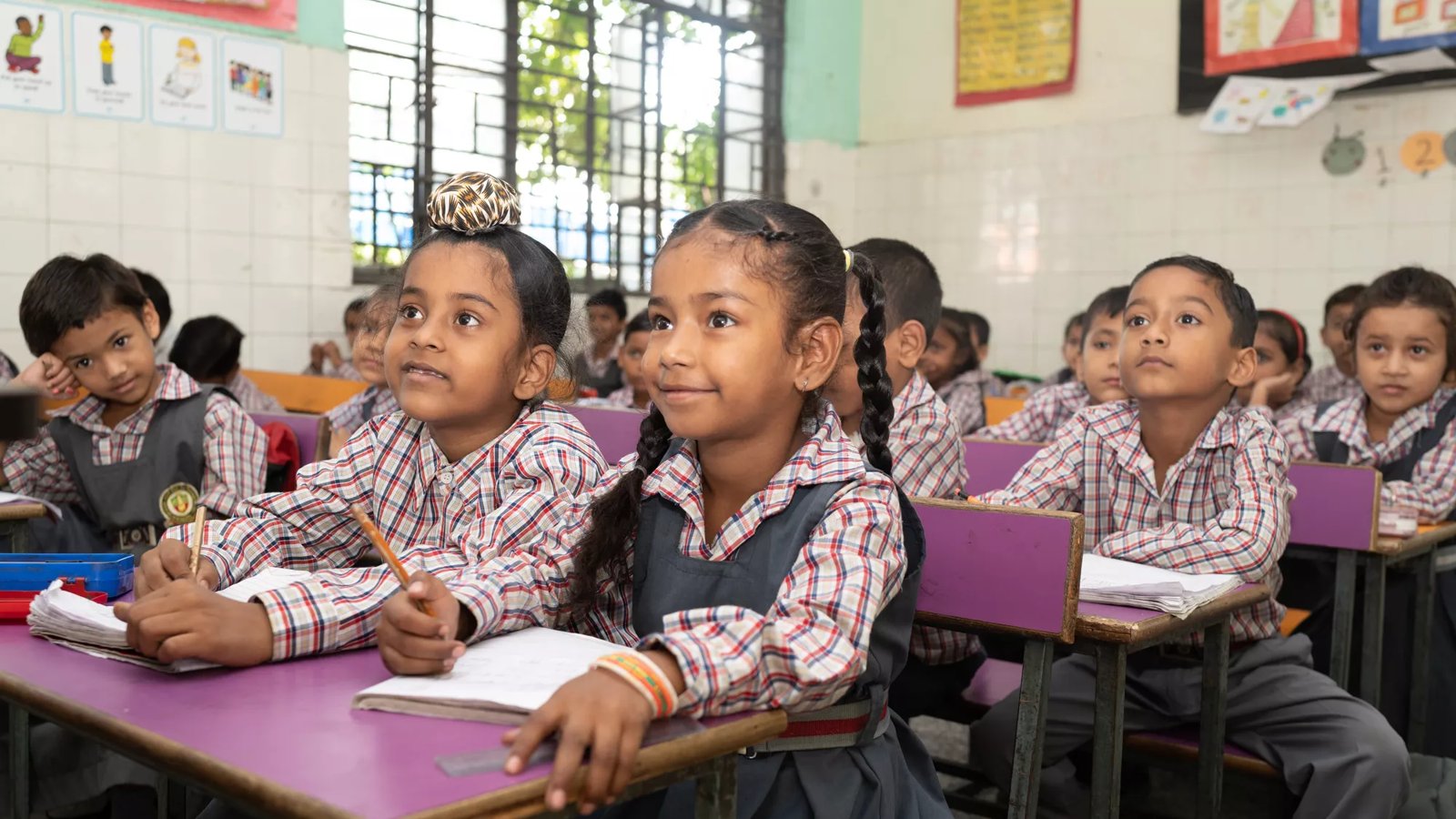 A group of Indian school children in a classroom.