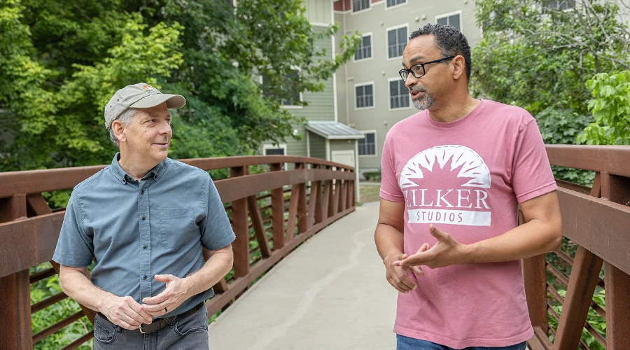 Two men walk across a pedestrian bridge in Austin, Texas.