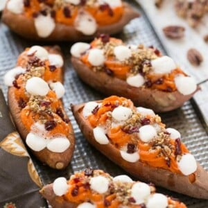 These loaded twice baked sweet potatoes are piled high with pecan brown sugar streusel, marshmallows and dried cranberries. You can prepare them in advance and then pop them in the oven right before your holiday meal!