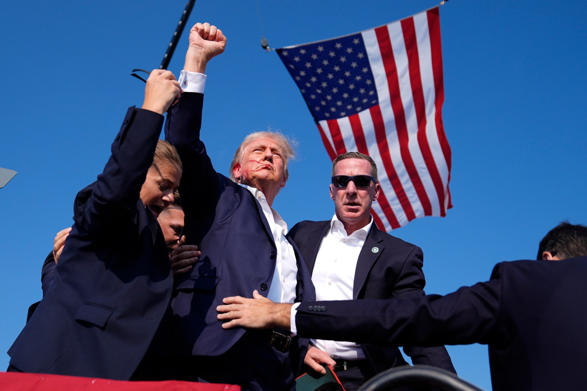 Republican presidential candidate former President Donald Trump is surrounded by U.S. Secret Service agents at a campaign rally, Saturday, July 13, 2024, in Butler, Pa. (AP Photo/Evan Vucci)