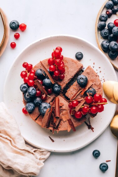 An overhead photo of a vegan chocolate tart. It has been sliced into 4 quarters.