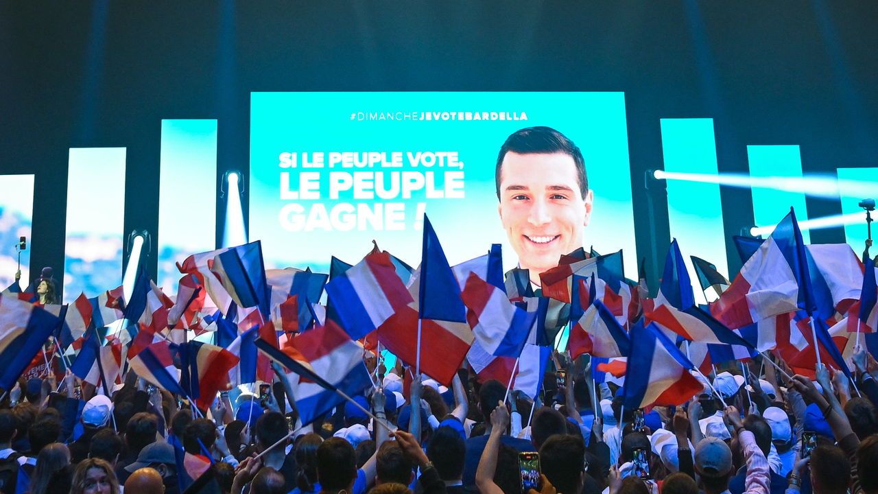 Jordan Bardella, is surrounded by supporters with French flags during his final rally ahead of the upcoming European Parliament election.