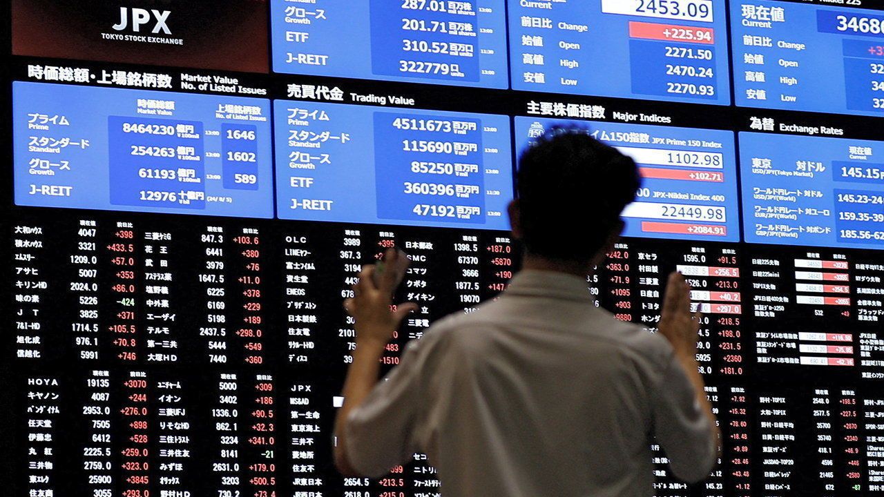 Media members observe the stock quotation board at the Tokyo Stock Exchange in Tokyo, Japan, August 6