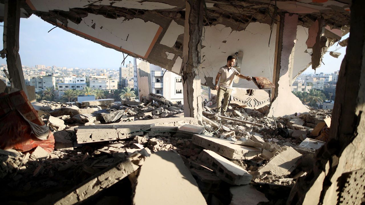 A man collects items from the rubble at the Nuseirat refugee camp in central Gaza