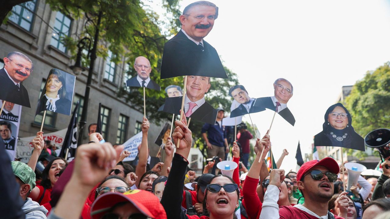 People hold photographs of the Supreme Court justices during a protest against a judicial reform, Mexico.