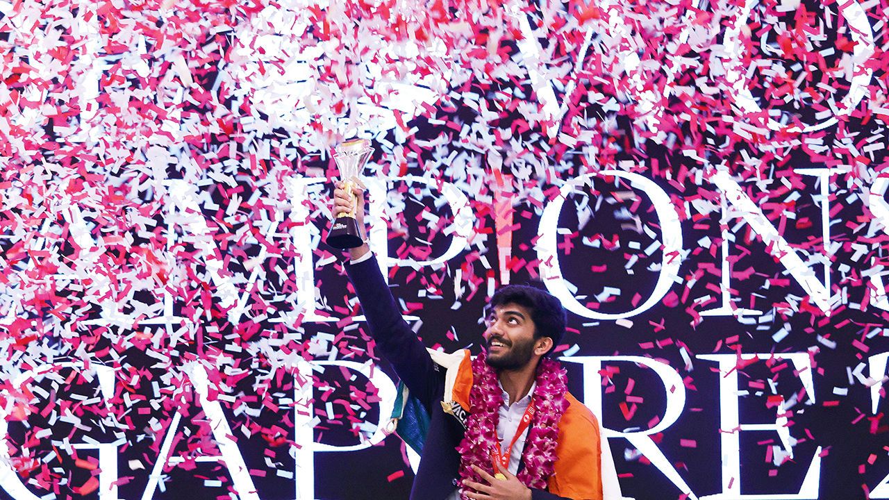 Chess grandmaster Gukesh Dommaraju of India celebrates with his trophy amid confetti in Singapore