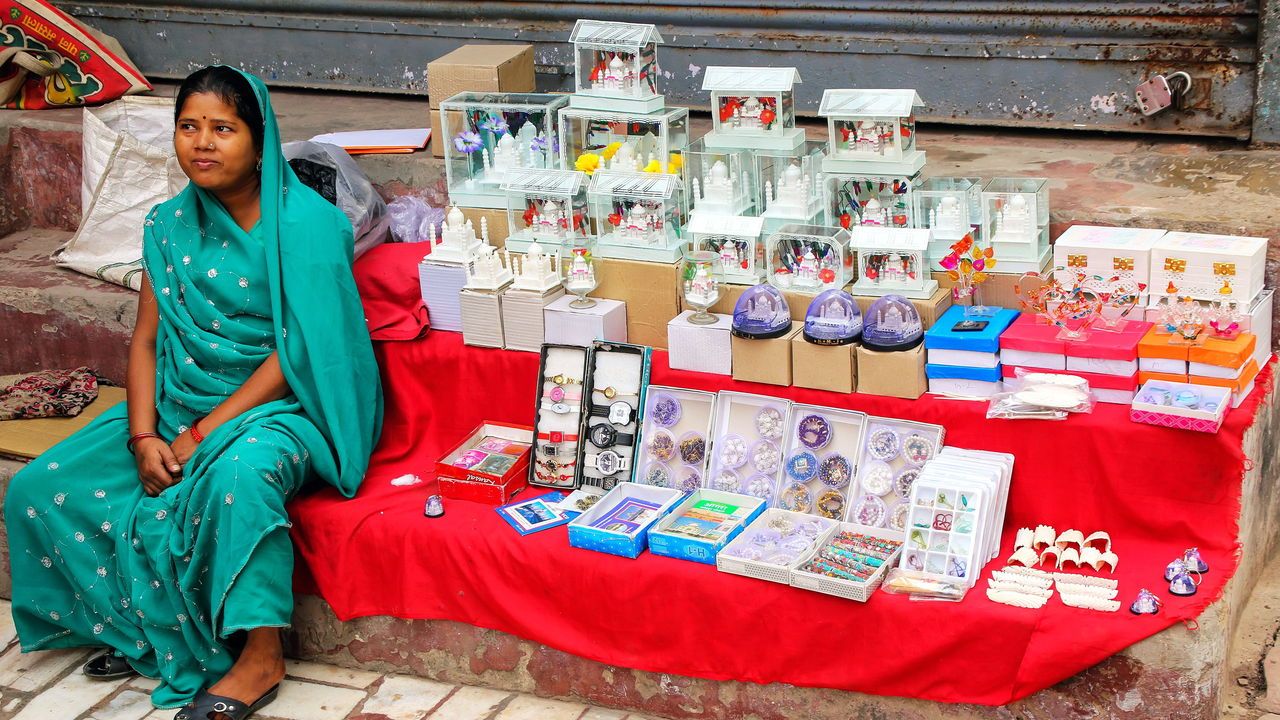 Local woman selling souvenirs in the street in Taj Ganj neighborhood of Agra, Uttar Pradesh, India.