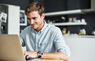 young man showing things on the monitor to a young woman