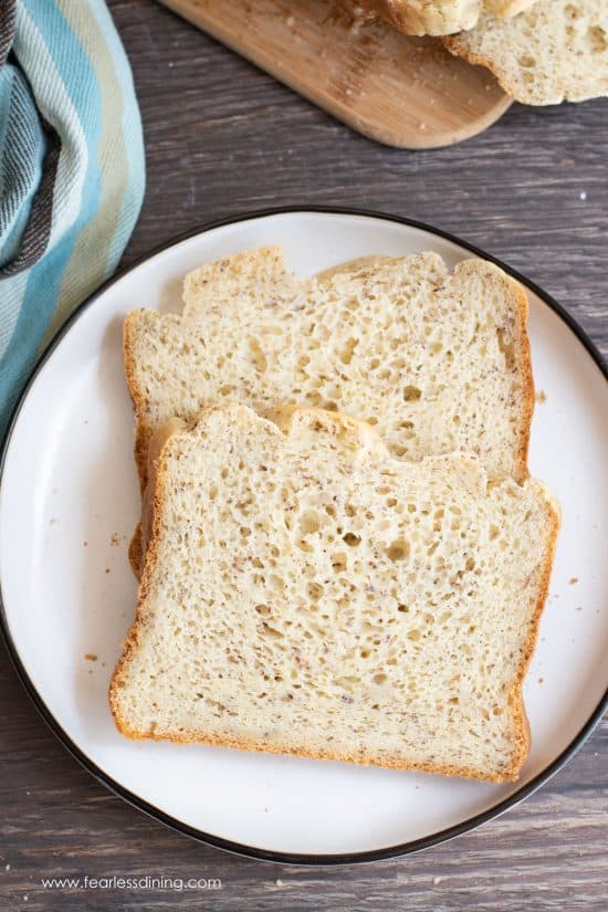 Two slices of gluten free bread machine bread on a plate.