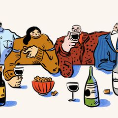 Four people drinking wine and having some snacks