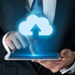 A man activates an arrow shooting up into a cloud sign on his phone, indicating share price movement in ASX tech shares