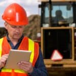 Miner looking at a tablet.