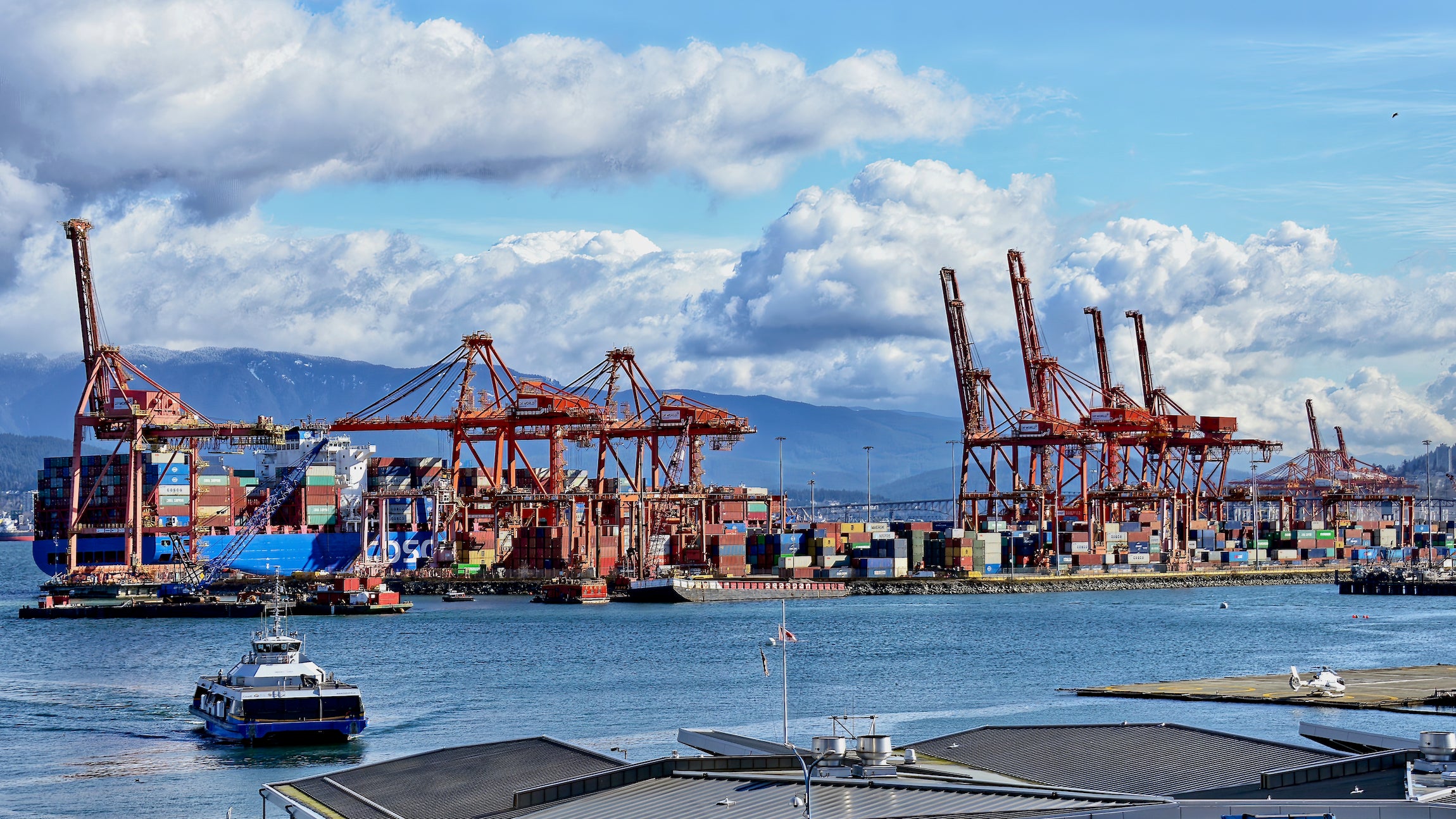 Shipping containers are off-loaded from a ship at a terminal at the Port of Vancouver