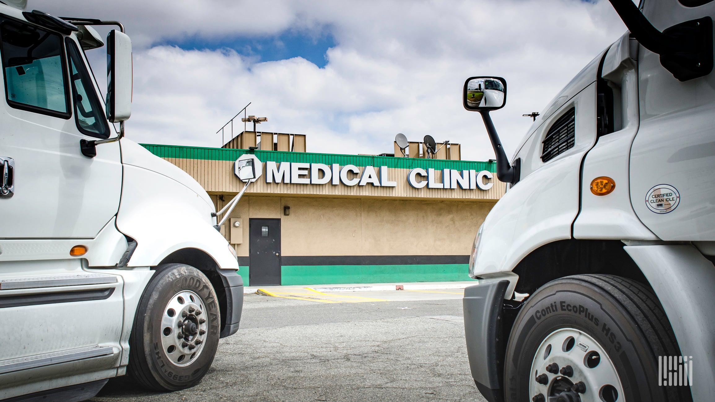 Two trucks parked at medical facility.