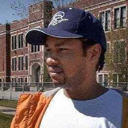 In this file photo, LaRon Bourgeois, the stepfather of Alexis Patterson, stands in the intersection near her Milwaukee school, where Alexis was last seen on May 3, 2002 at the age of 7.