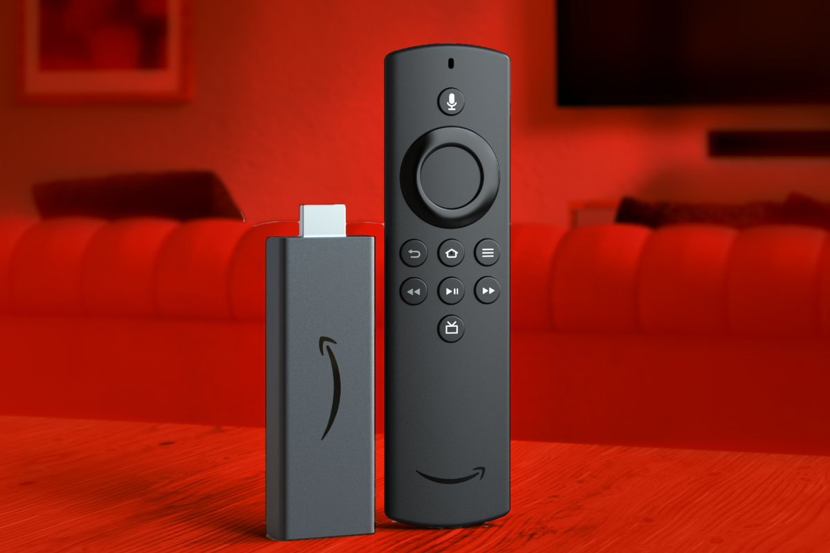a fire tv stick pictured on a table with a living room seen in the background 