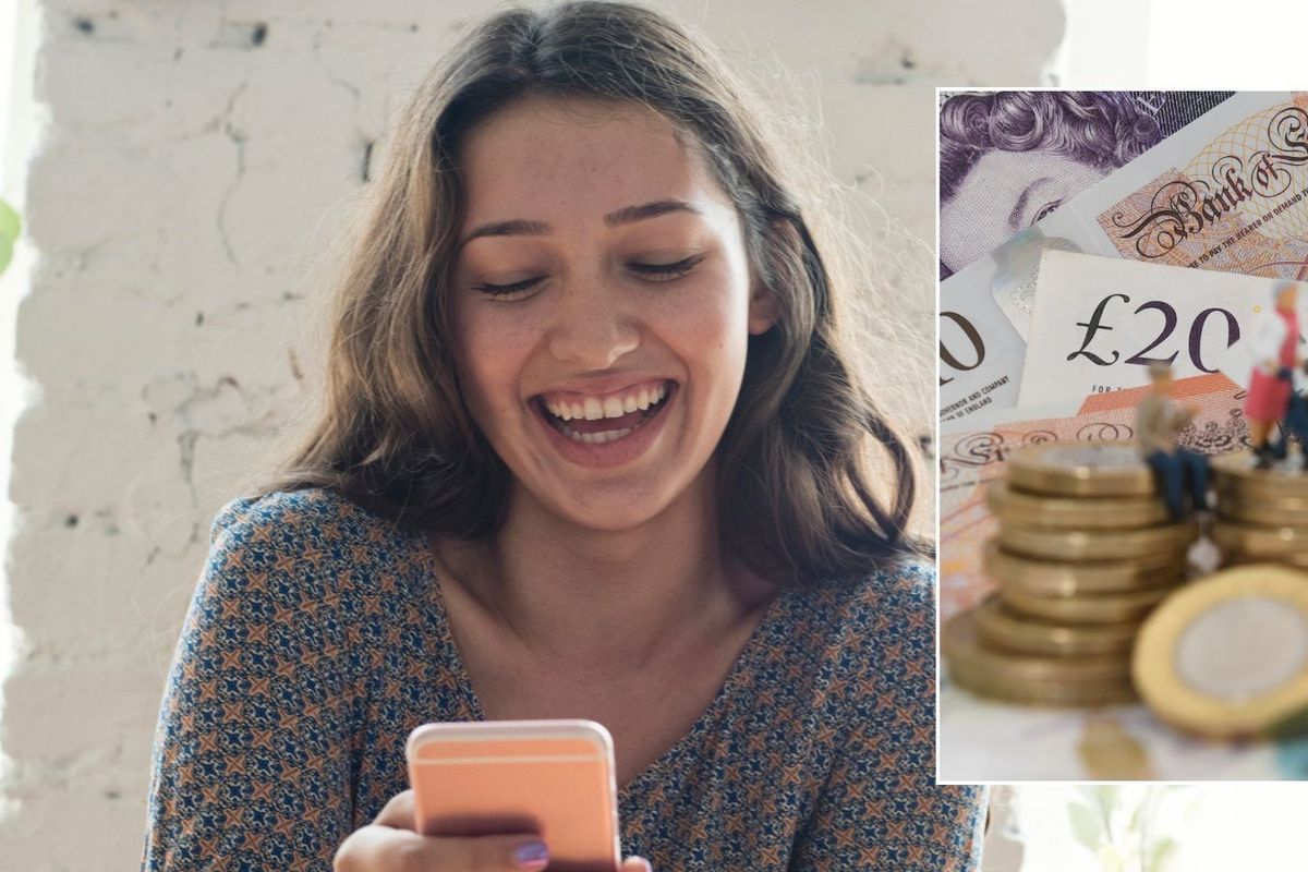 Woman happy looking at phone and money 