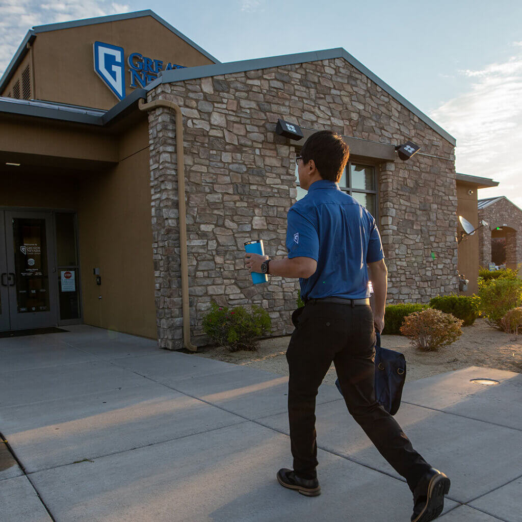 GNCU employee walking into a branch