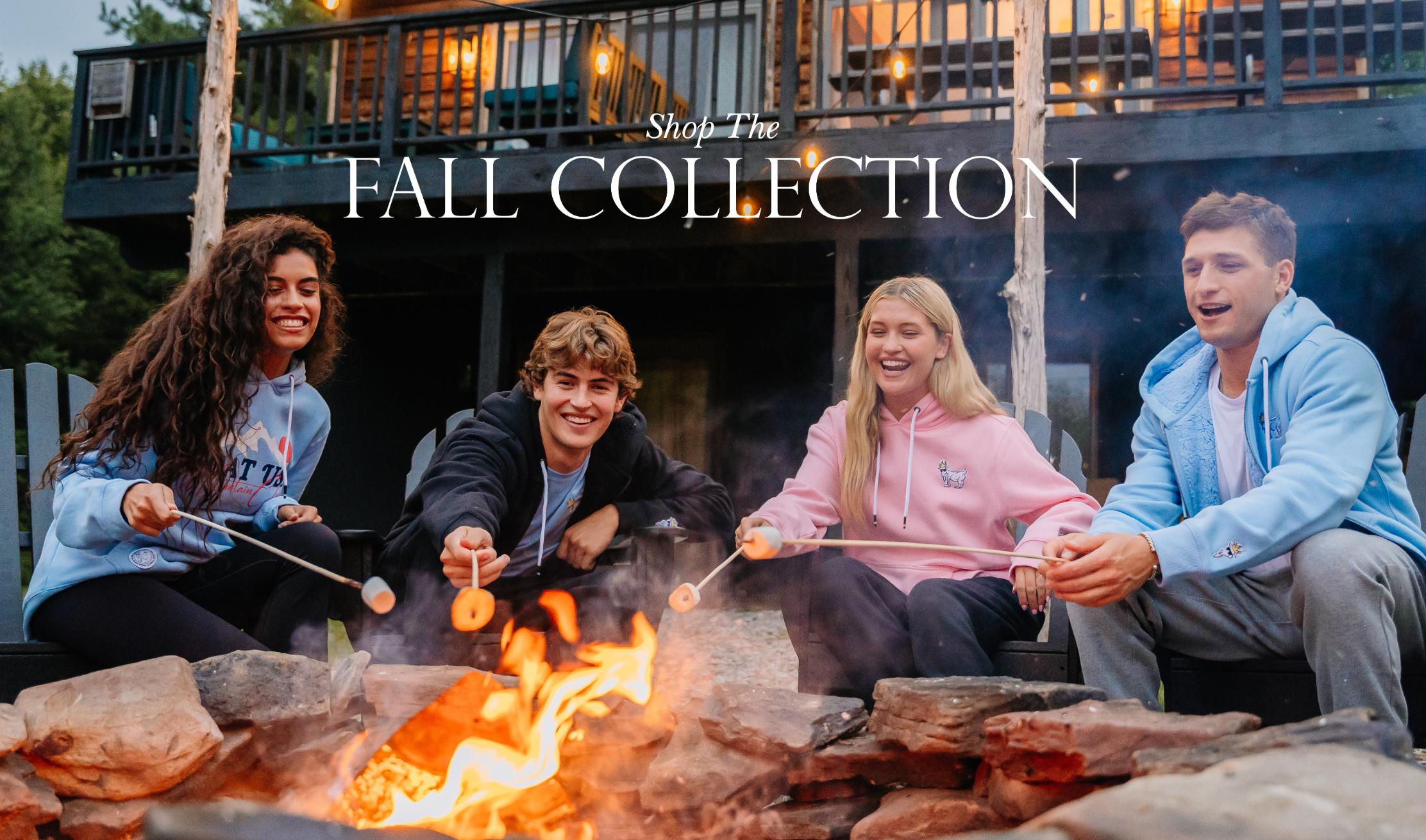 Men and women roasting marshmallows around a fire