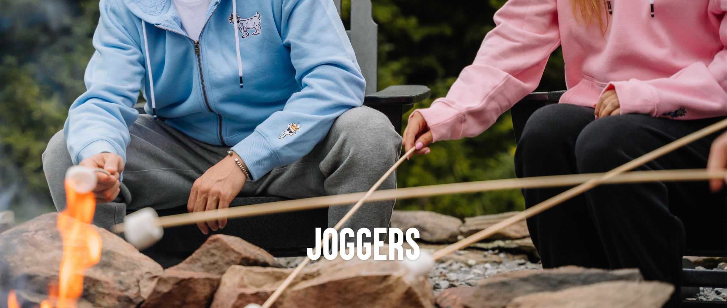 Shot of two people's pants while they are roasting marshmallows