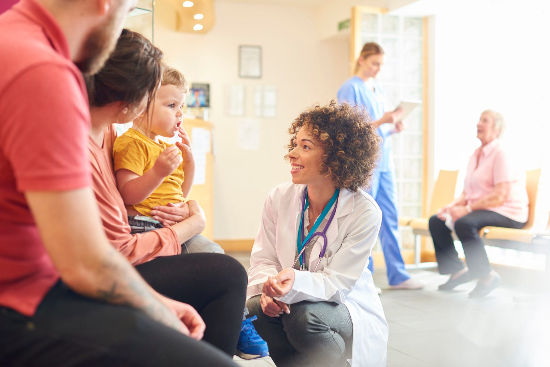 Toddler talking to female doctor