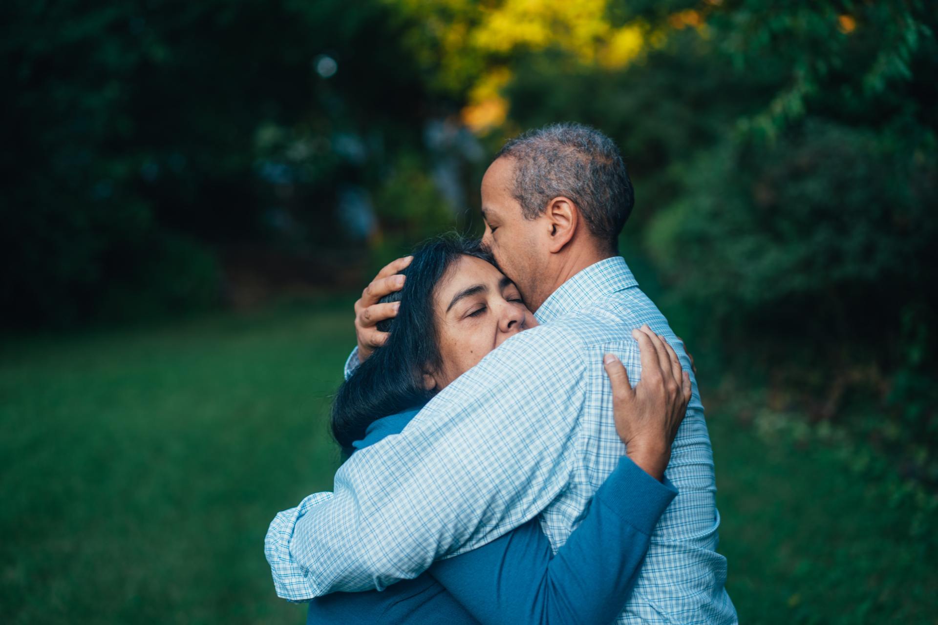 Two people hugging outside