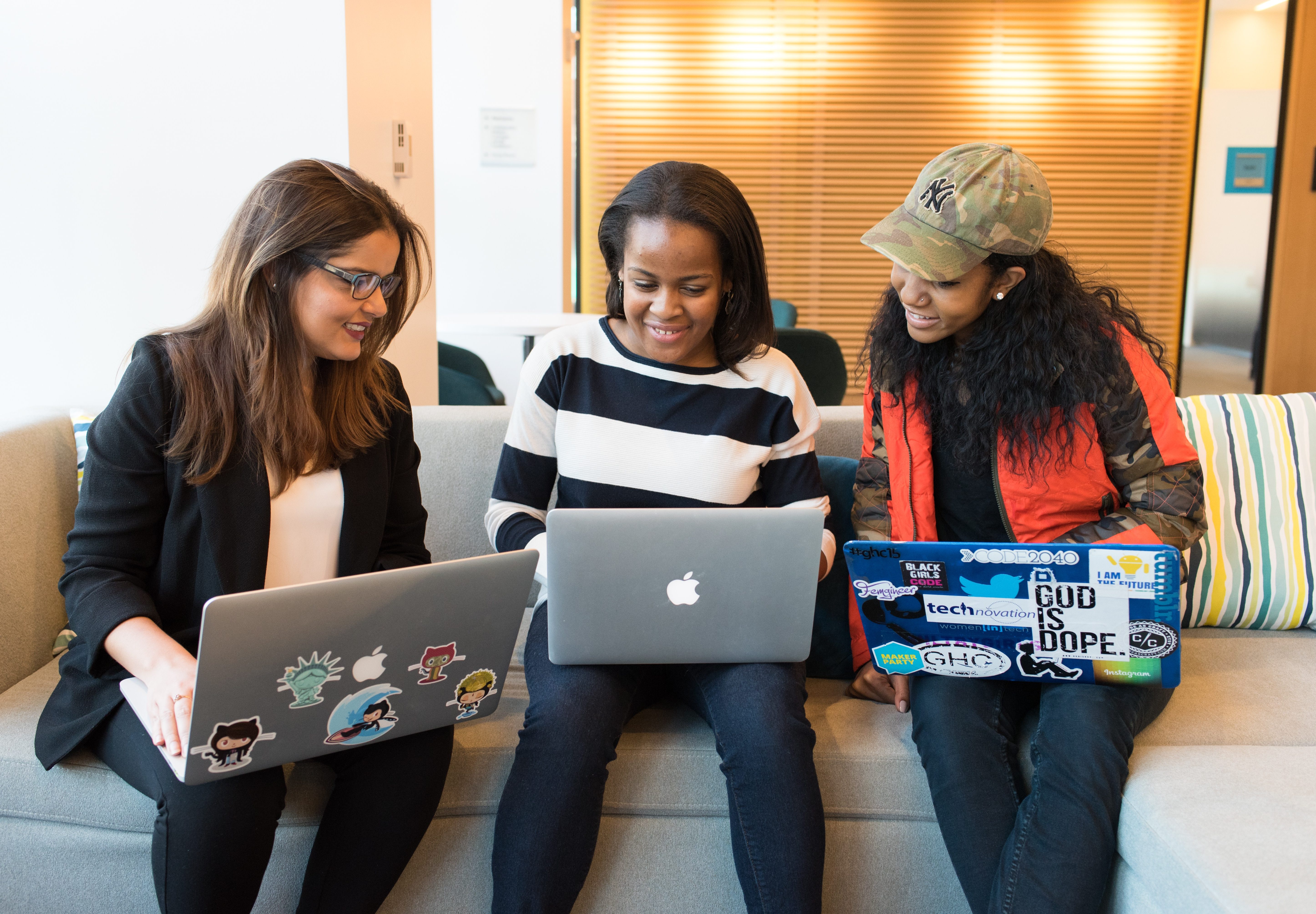 Three friends on their computers