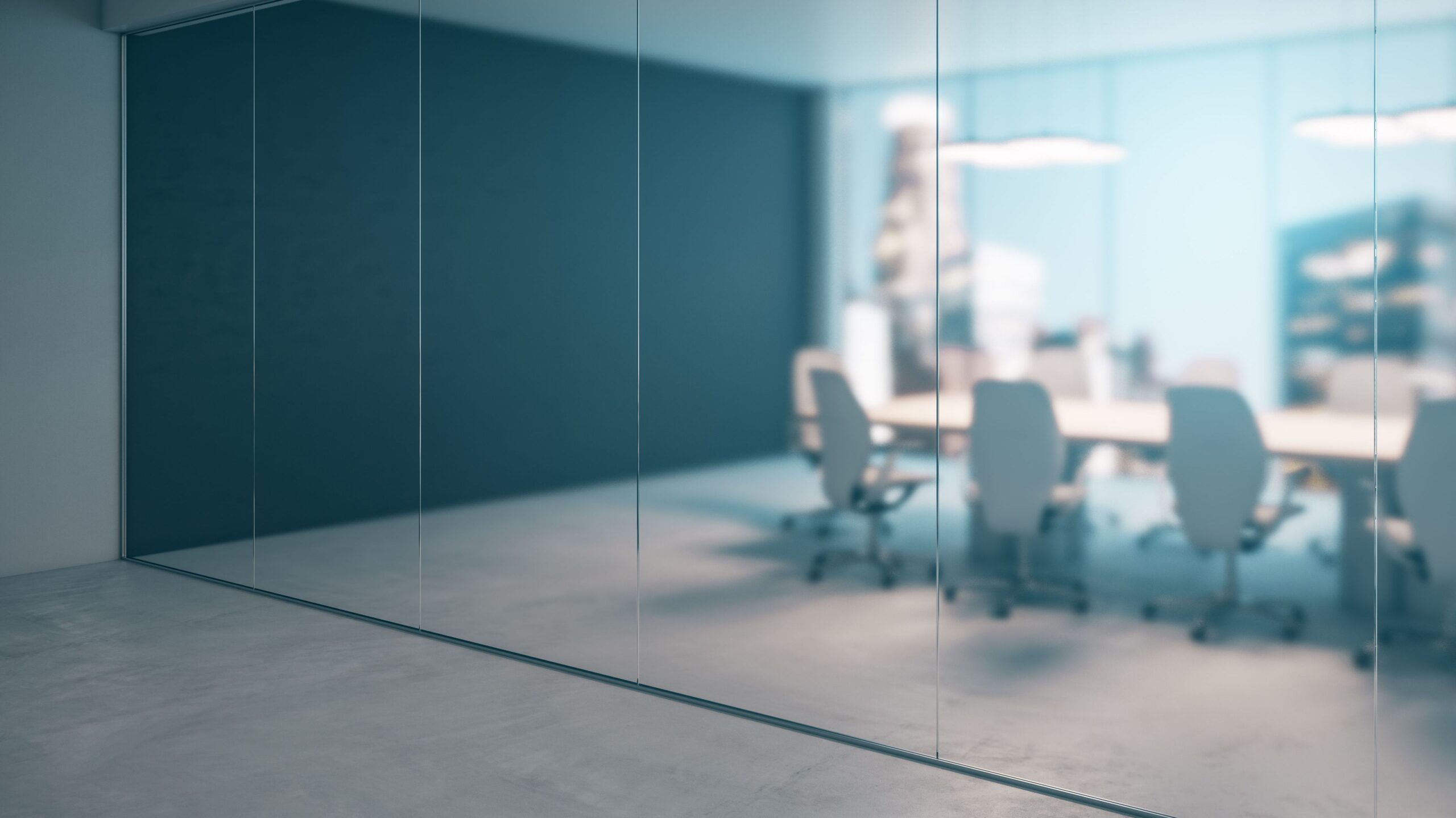 View of conference room and blurred background of outside buildings.