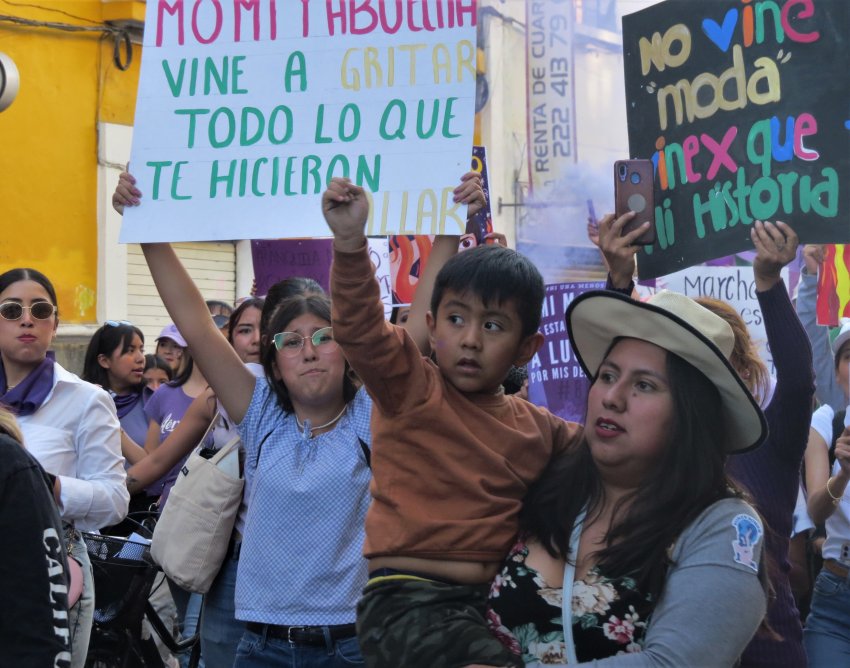 Women and children marching for International Women's Day in Puebla Mexico