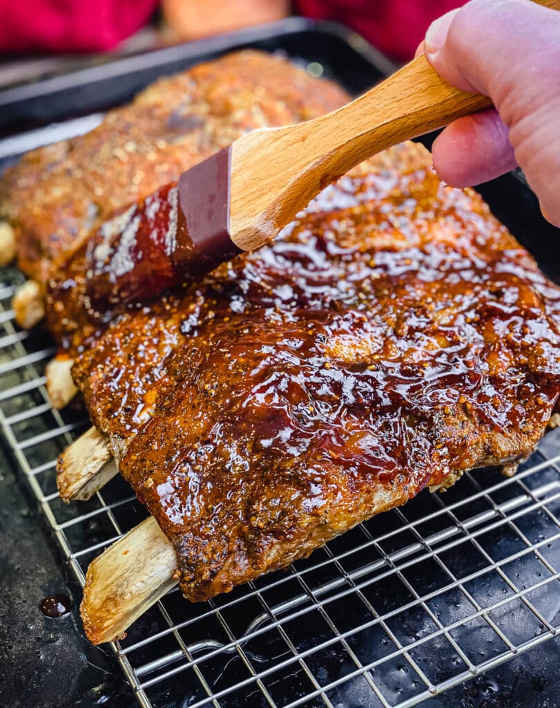 bbq sauce covering oven baked beef ribs 