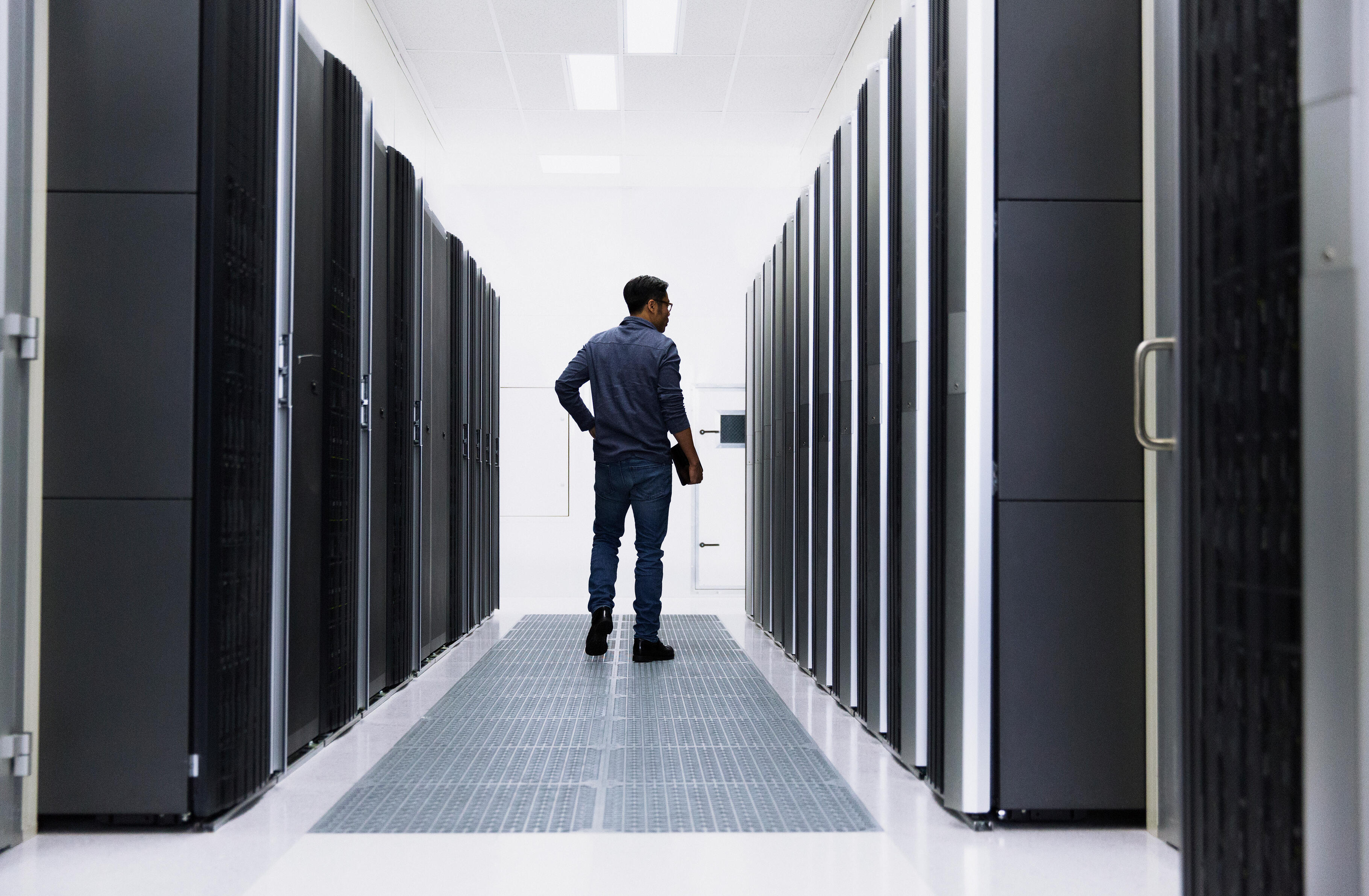 An individual standing in a datacenter