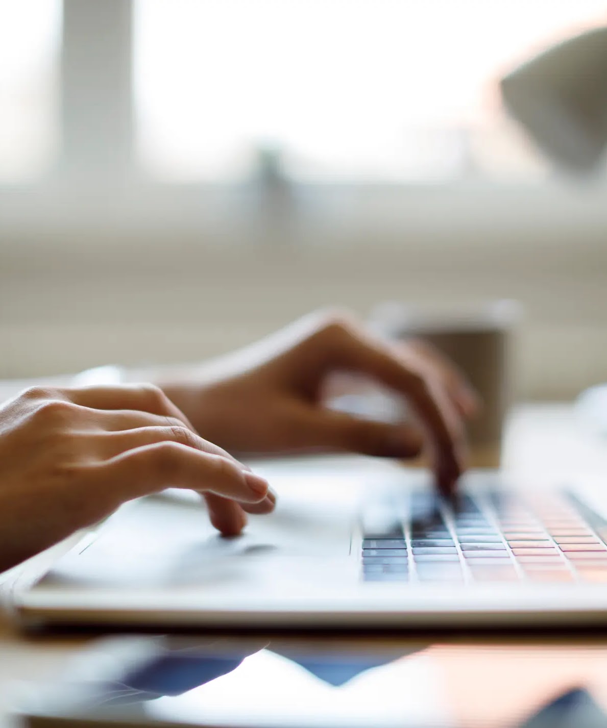 Close up of someone using their laptop while working from home