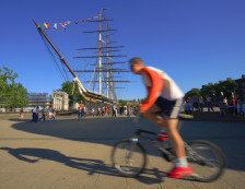 Greenwich, London - Cyclist passing the Cutty Sark. Photo Credit: ©Visit London Images.