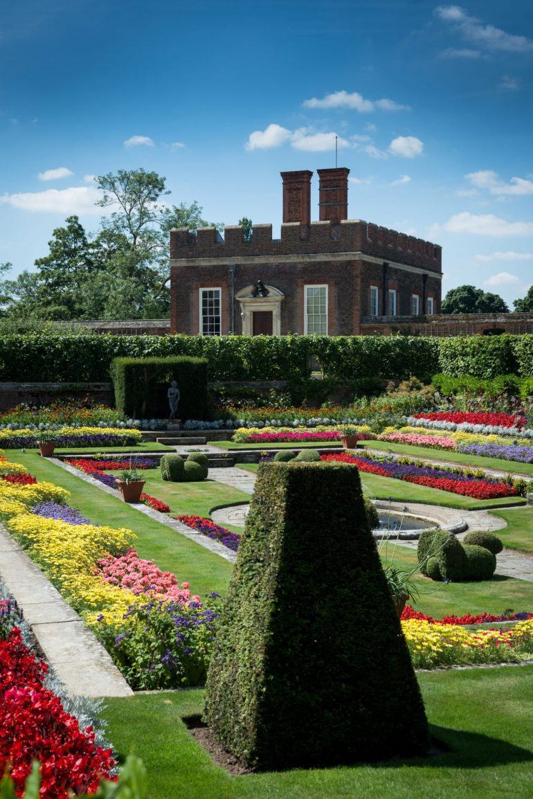 Hampton Court Palace - In the 16th century, the sunken compartments of Henry VIII's ponds were stocked with fish for the palace kitchens but by 1690 the ponds had been drained. Queen Mary II found the sheltered south-facing gardens an ideal place to house the collection of exotic plants she brought with her from the Netherlands. Today the gardeners make a splash with spring and summer bedding.