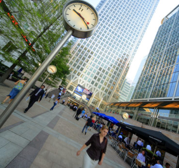 People beneath skyscrapers at Canary Wharf in London's Docklands business district. Photo Credit: ©Visit London Images.