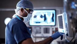 Surgeon standing in front of a monitor