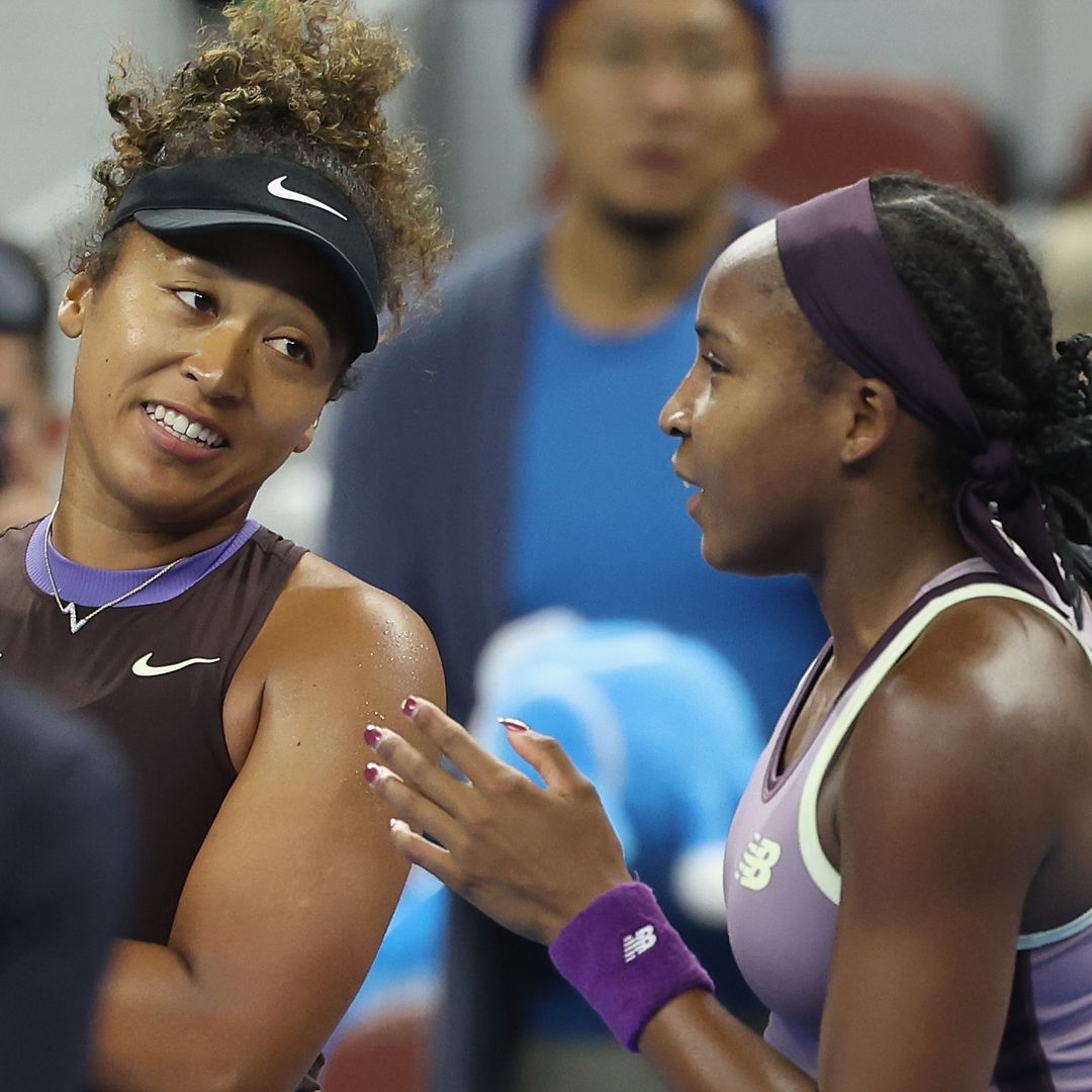 Naomi Osaka is helped off the court by Coco Gauff after forfeiting tennis match