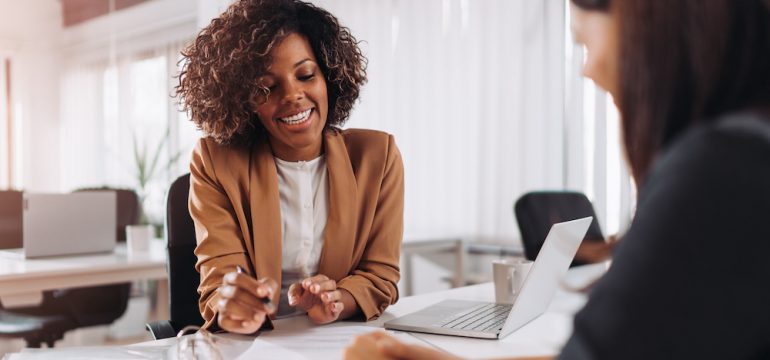 Female client consulting with a real estate attorney in the office.