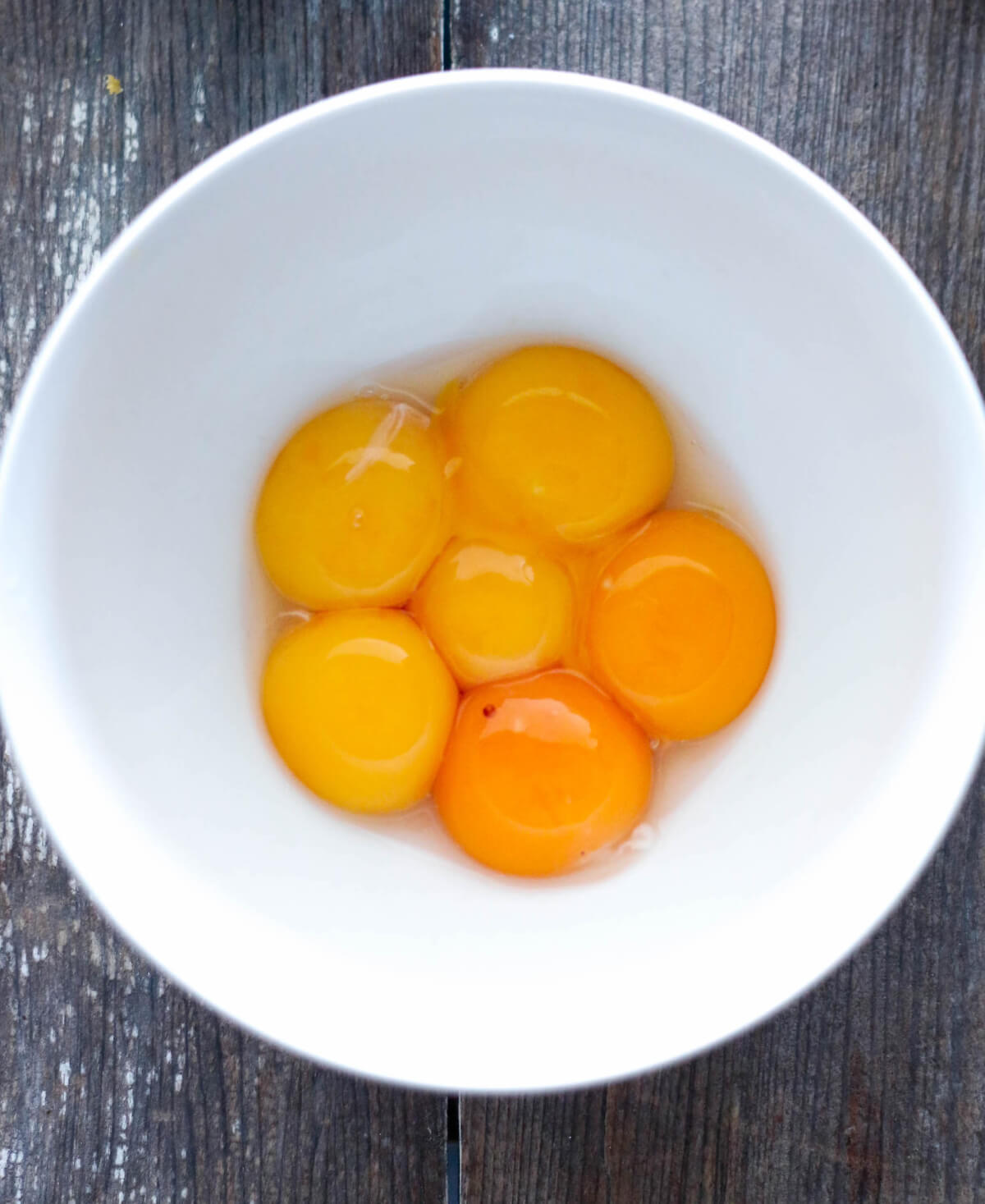 6 Egg yolks in white bowl