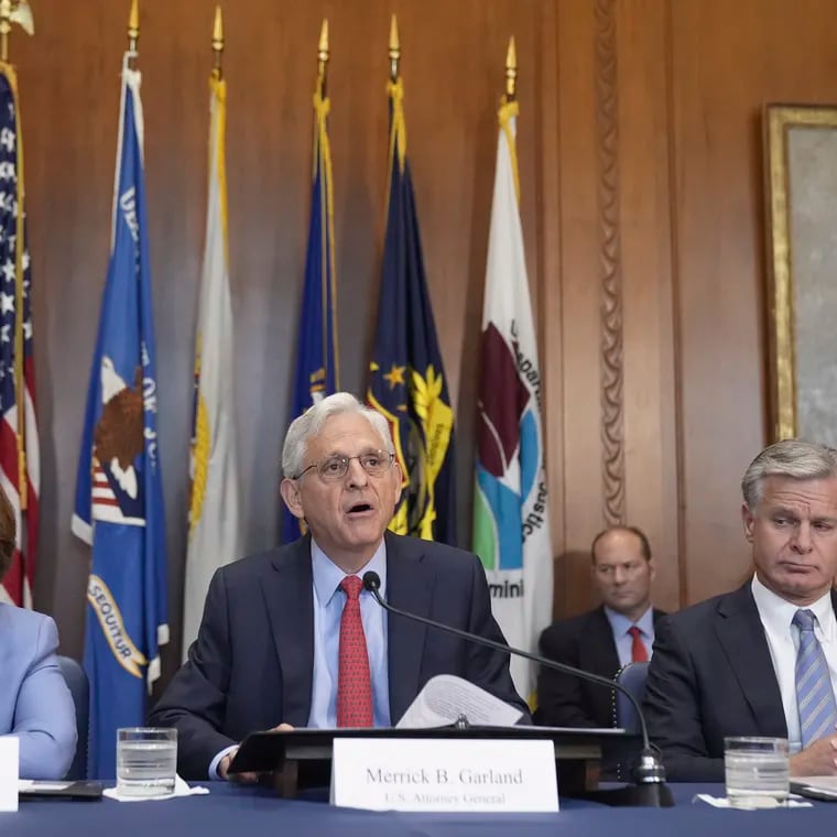 Attorney General Merrick Garland speaks during a meeting of the Justice Department's Election Threats Task Force on Wednesday in Washington, with Deputy Attorney General Lisa Monaco (left) and FBI Director Christopher Wray (right)