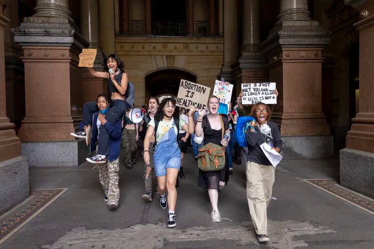 High schoolers from Philadelphia walk through the north portal of Philadelphia's City Hall to meet up with other students to protest for abortion rights on May 25, 2022.