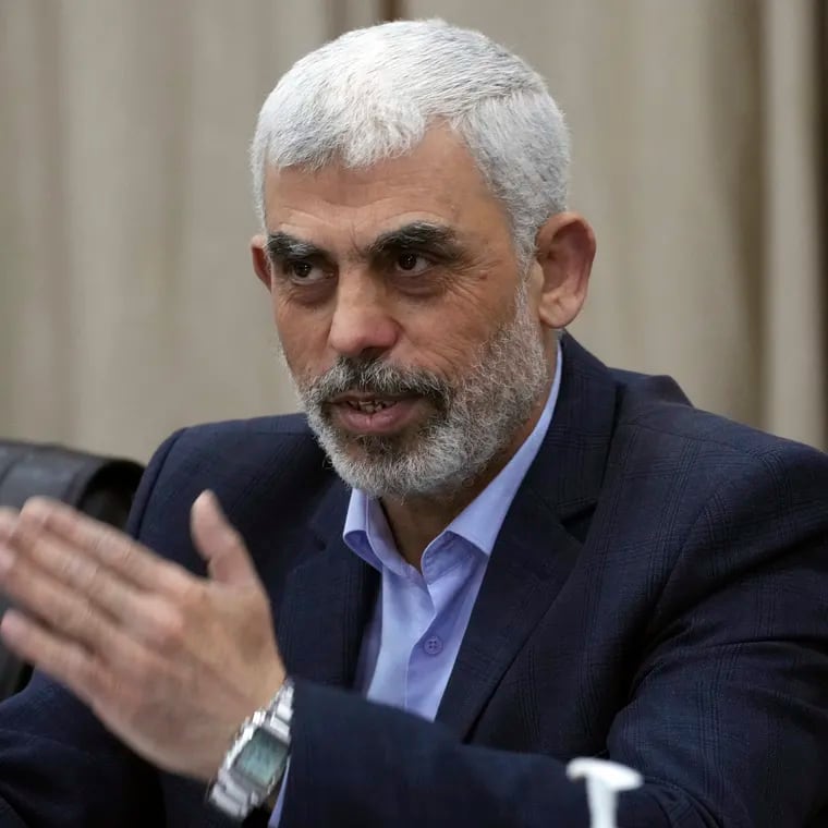 Yahya Sinwar, head of Hamas in Gaza, greets his supporters during a meeting with leaders of Palestinian factions at his office in Gaza City, Wednesday, April 13, 2022.