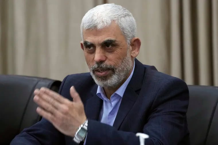 Yahya Sinwar, head of Hamas in Gaza, greets his supporters during a meeting with leaders of Palestinian factions at his office in Gaza City, Wednesday, April 13, 2022.