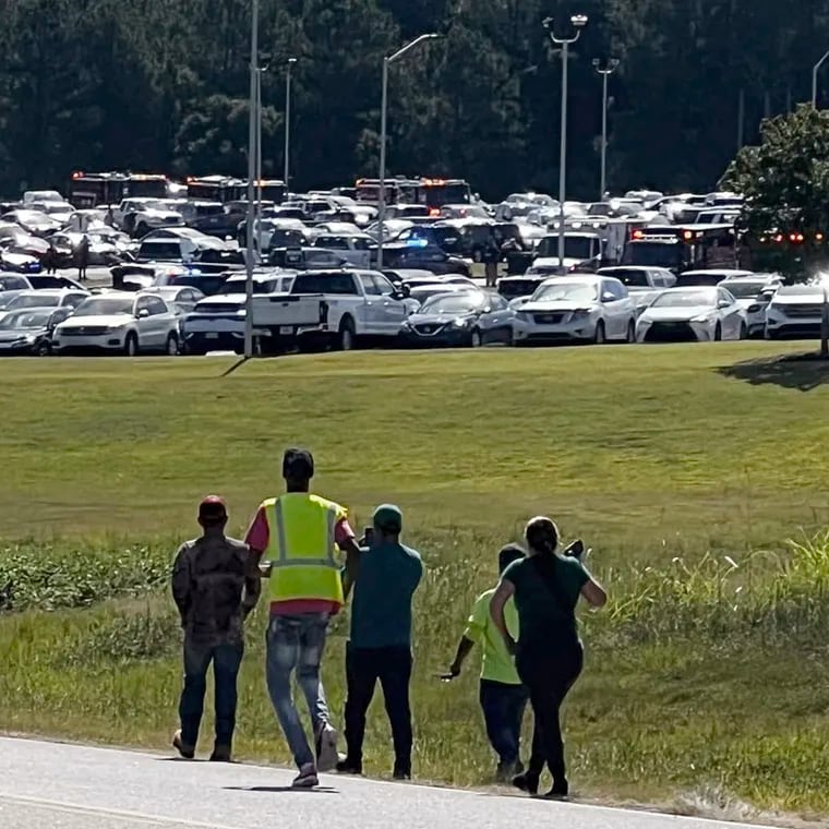 Students are evacuated to the football stadium after the school campus was placed on lockdown at Apalachee High School in Winder, Ga., on Wednesday.