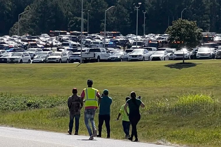 Students are evacuated to the football stadium after the school campus was placed on lockdown at Apalachee High School in Winder, Ga., on Wednesday.