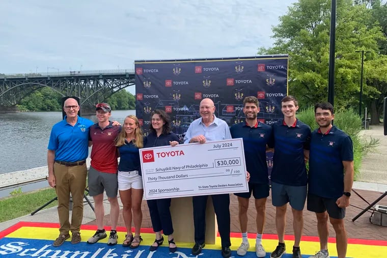 Paul Muller (right center) of Team Toyota of Langhorne presents Bonnie Mueller (left center) and the Schuylkill Navy with a $30,000 check from the Tri-State Toyota Dealers.