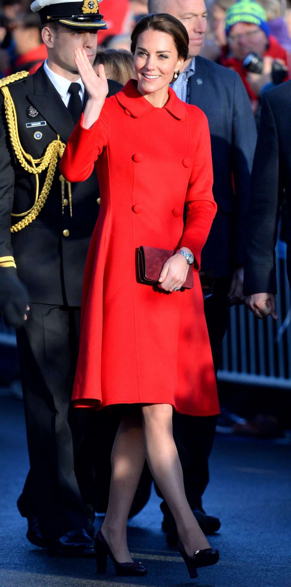 Kate Middleton in a red CH Carolina Herrera double-breasted coat and black pumps 