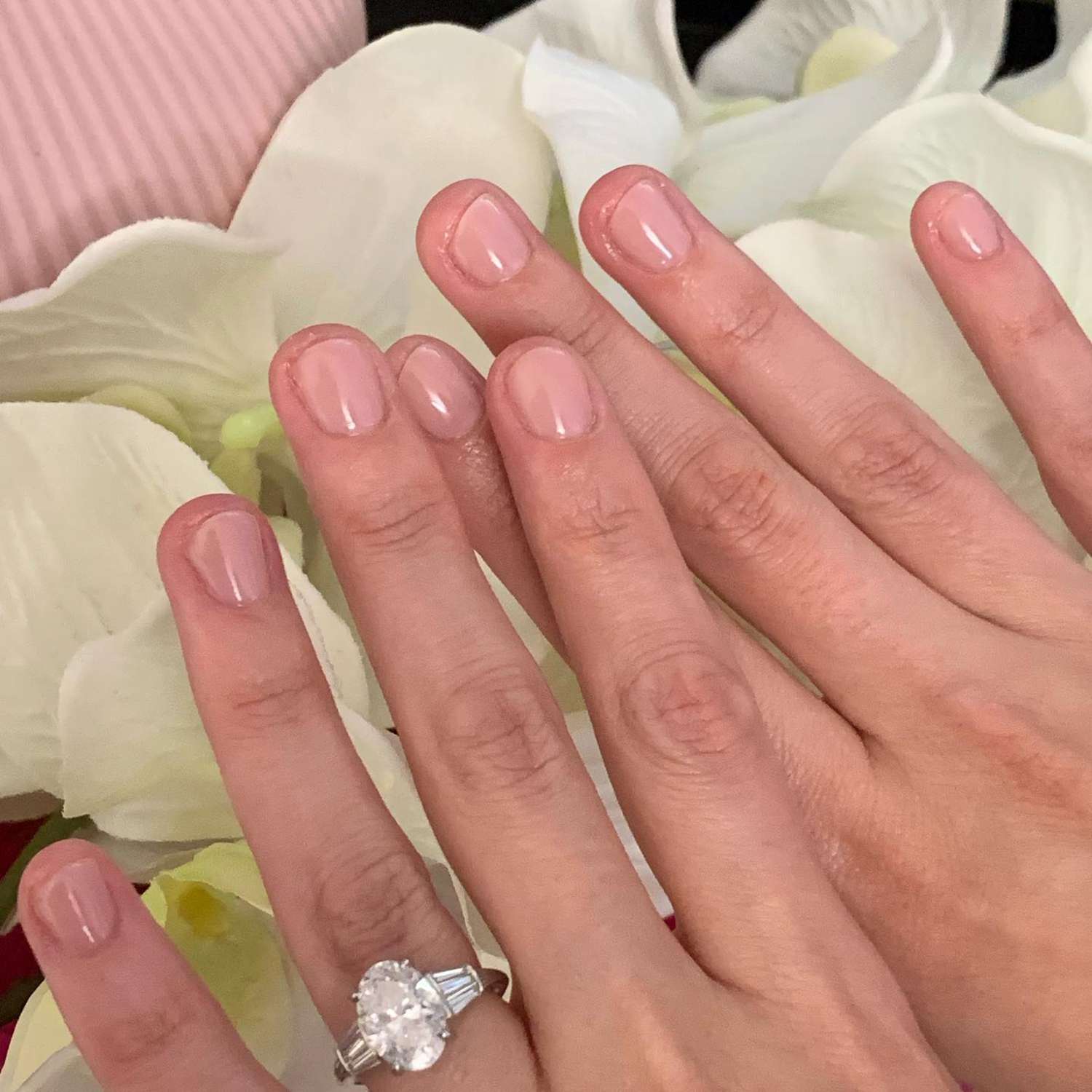 close up of nails with light pink manicure